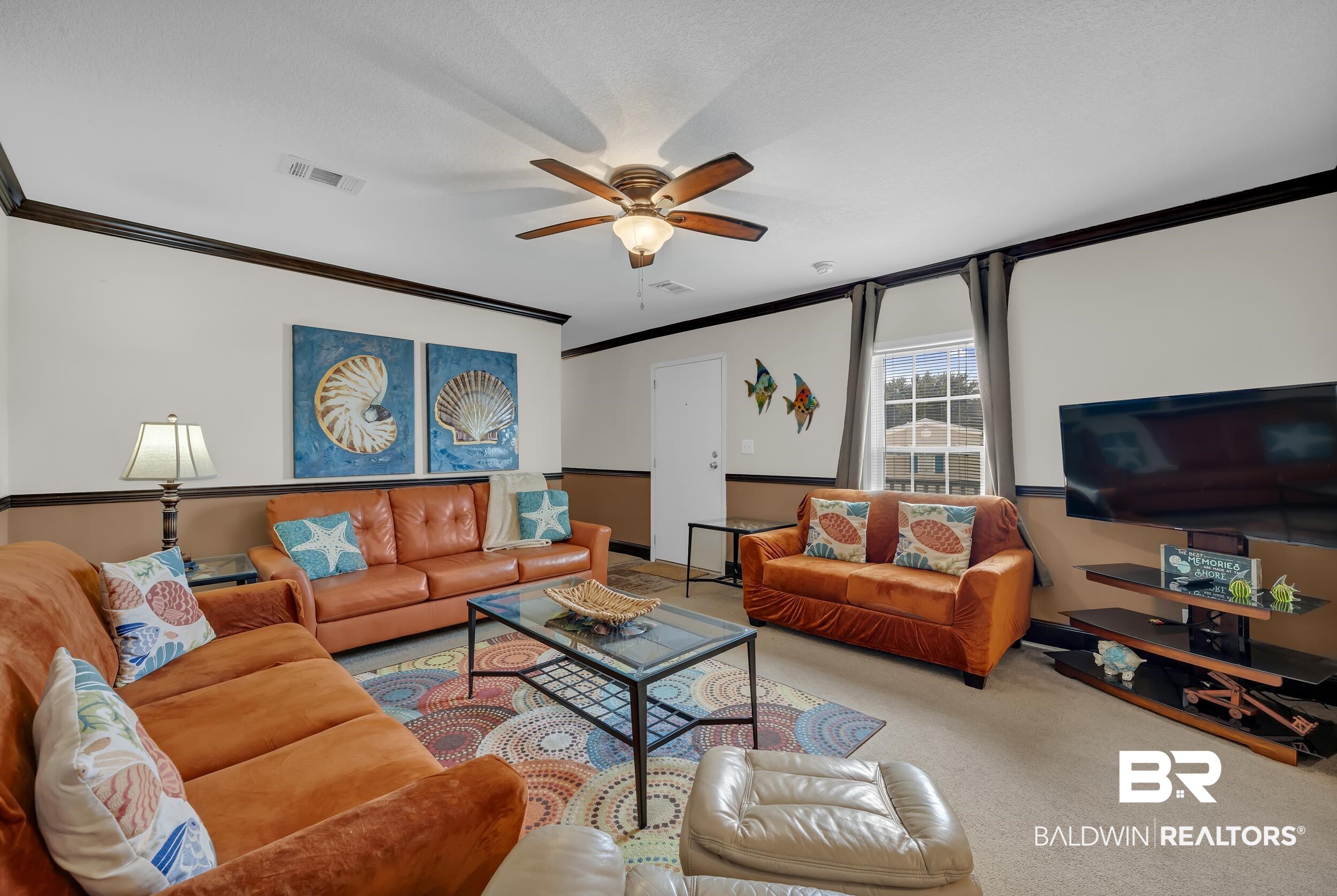 16707 Fort Morgan Road, Unit 8 Gulf Shores, AL 36542 - Photo 16 of 27 Carpeted living area featuring crown molding and a ceiling fan