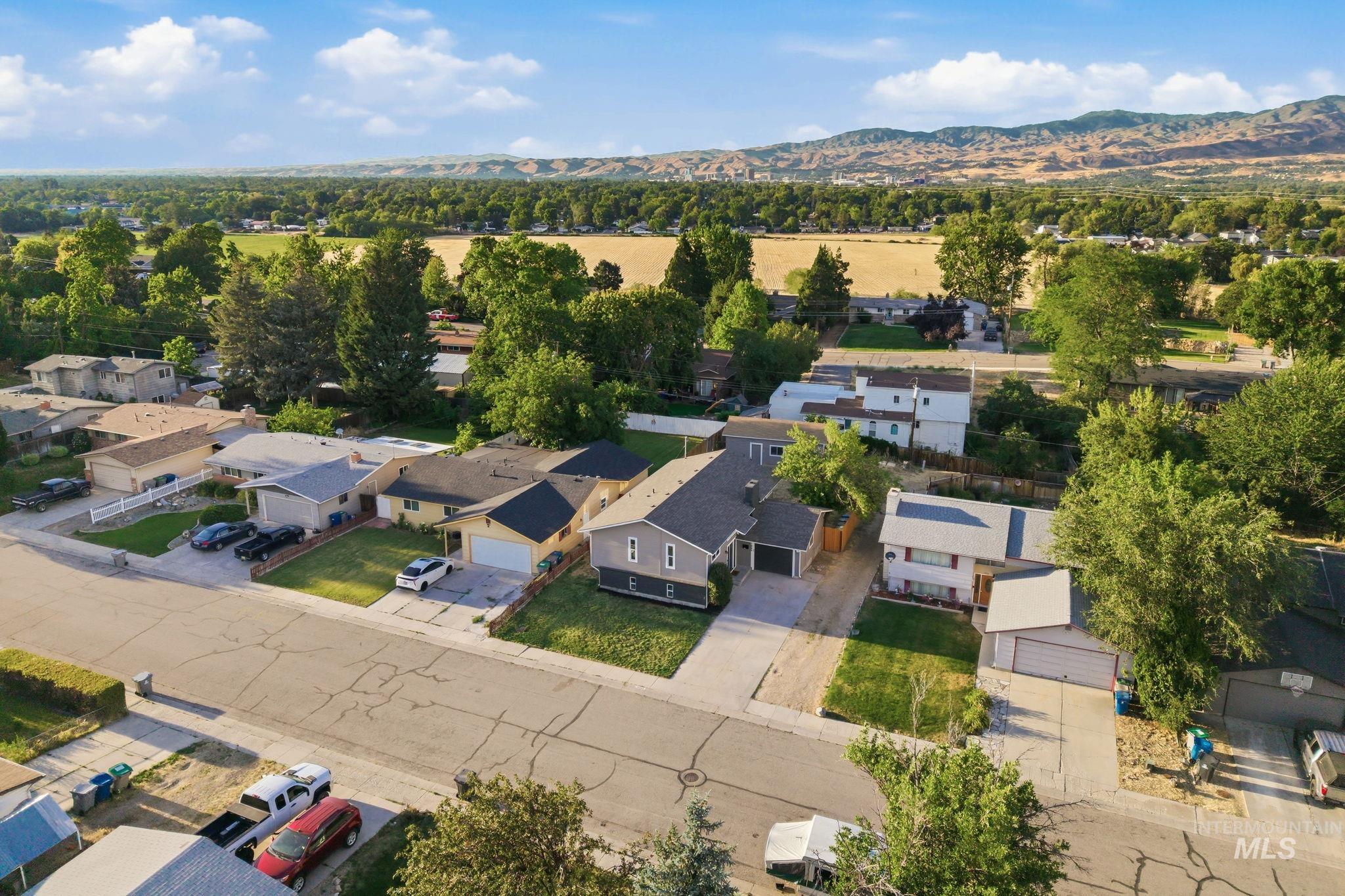 1990 Panama Street Boise, ID 83705 - Photo 49 of 50 Suburban streetscape featuring a single-family residence with a gray exterior, a paved driveway, and an attached garage