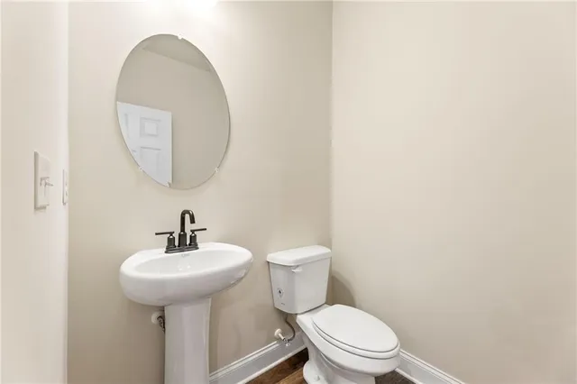 a bathroom with a sink a mirror and a toilet