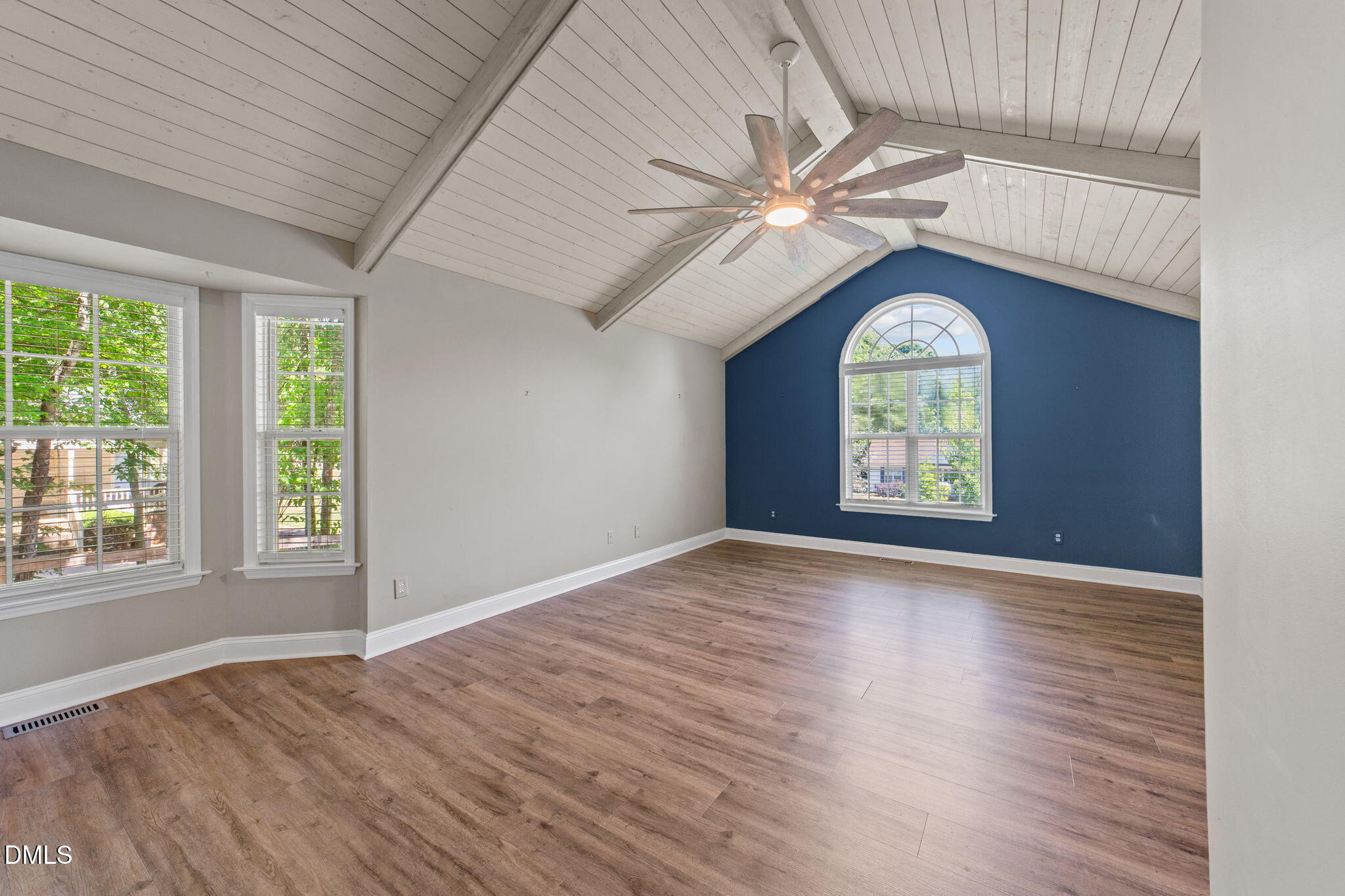 6820 Oviedo Drive Raleigh, NC 27603 - Photo 22 of 50 an empty room with wooden floor fan and windows