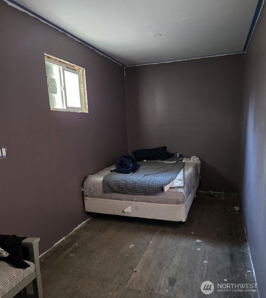 18820 220th Avenue Southeast Maple Valley, WA 98038 - Photo 11 of 16 a bed sitting in a room next to a window