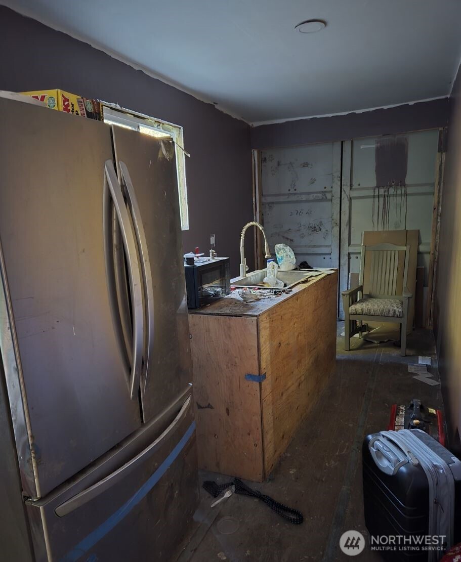 18820 220th Avenue Southeast Maple Valley, WA 98038 - Photo 9 of 16 a room with water heater and a cabinet