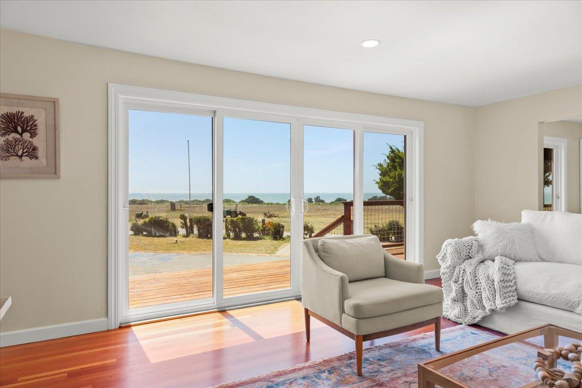 1263 Reservoir Road Pescadero, CA 94060 - Photo 32 of 75 a living room with furniture and a floor to ceiling window