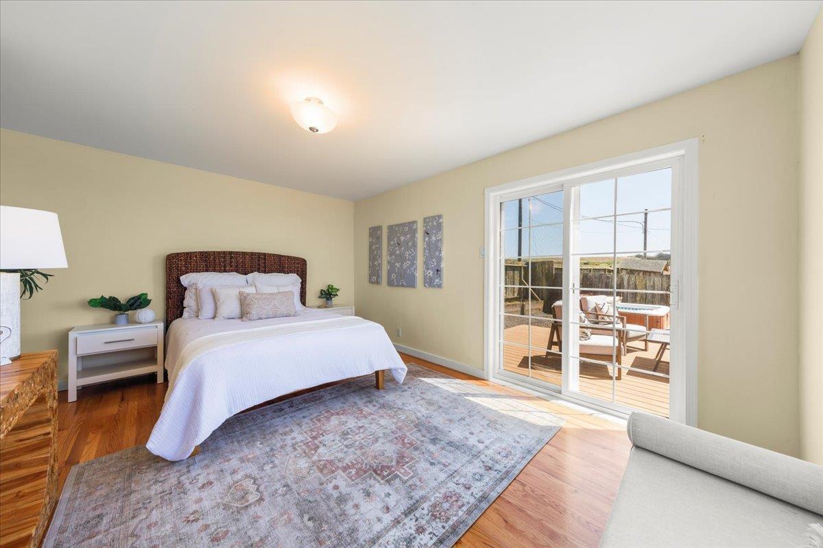 1263 Reservoir Road Pescadero, CA 94060 - Photo 43 of 75 a bedroom with a large bed and wooden floor