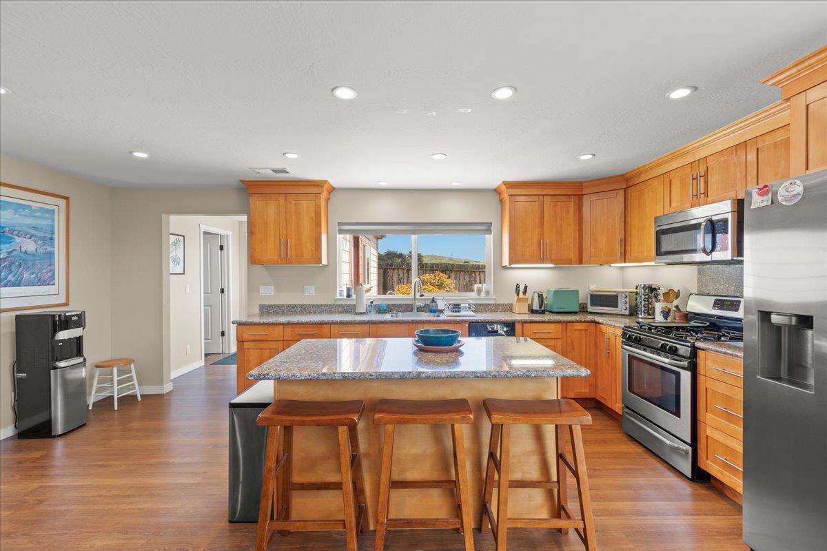 1263 Reservoir Road Pescadero, CA 94060 - Photo 65 of 75 a kitchen with stainless steel appliances granite countertop a stove refrigerator sink and cabinets