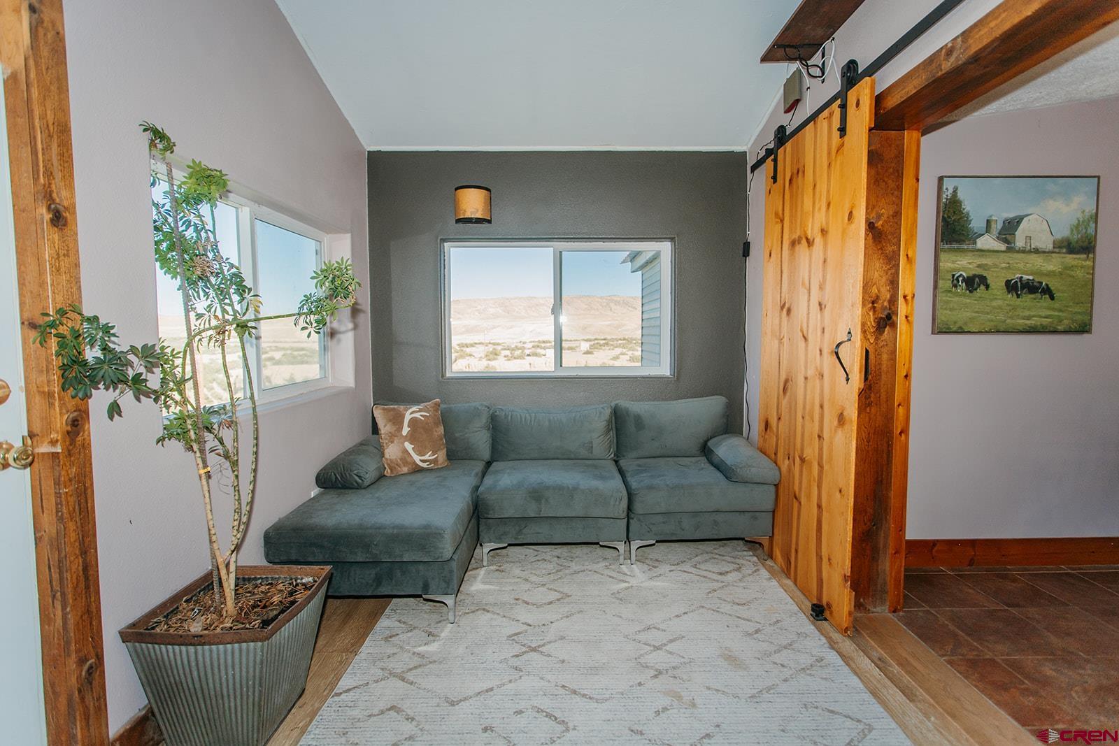 5697 Peach Valley Road Delta, CO 81416 - Photo 15 of 31 a living room with furniture and a window