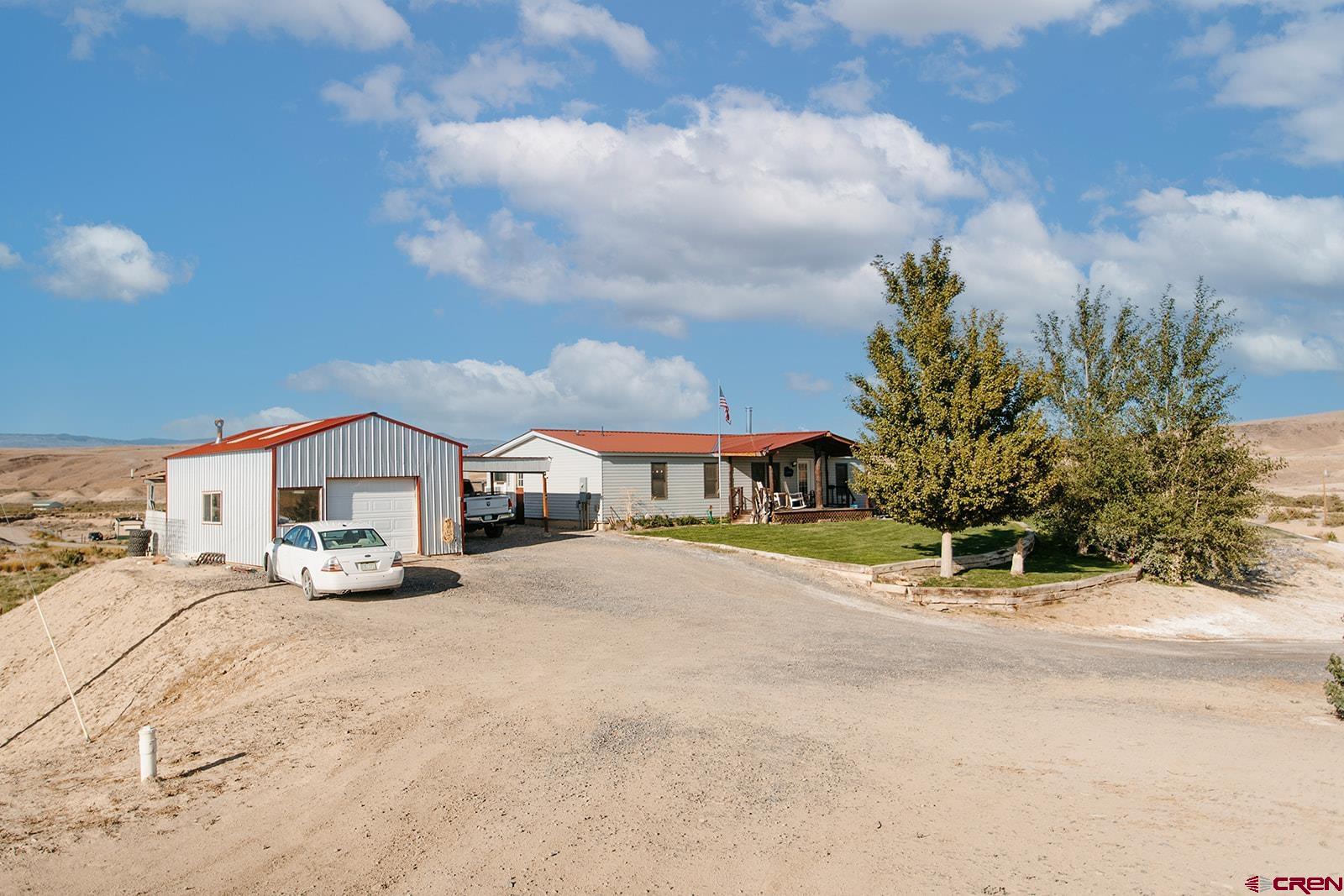 5697 Peach Valley Road Delta, CO 81416 - Photo 19 of 31 a view of house with yard and entertaining space