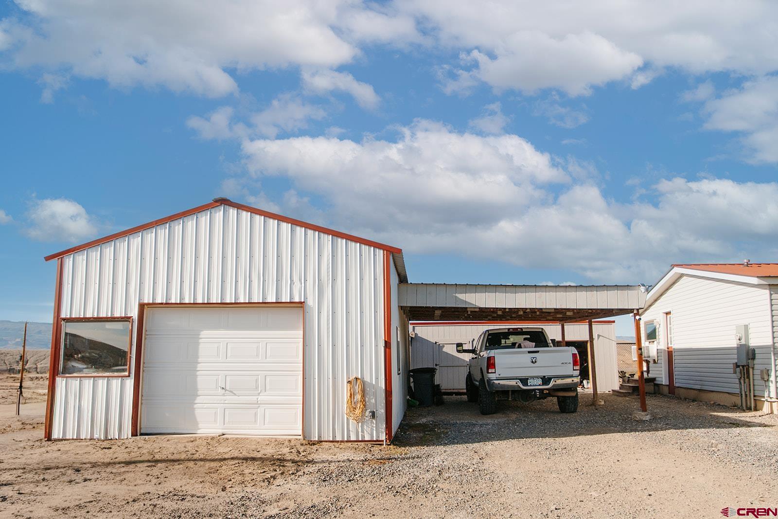 5697 Peach Valley Road Delta, CO 81416 - Photo 24 of 31 a front view of a house with a parking space