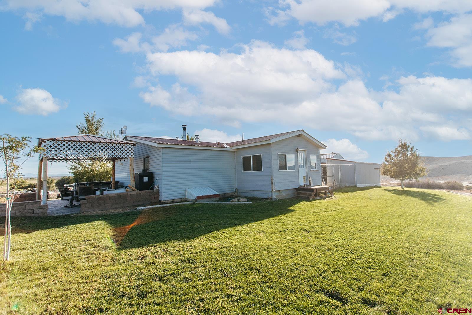 5697 Peach Valley Road Delta, CO 81416 - Photo 28 of 31 a house view with swimming pool and yard