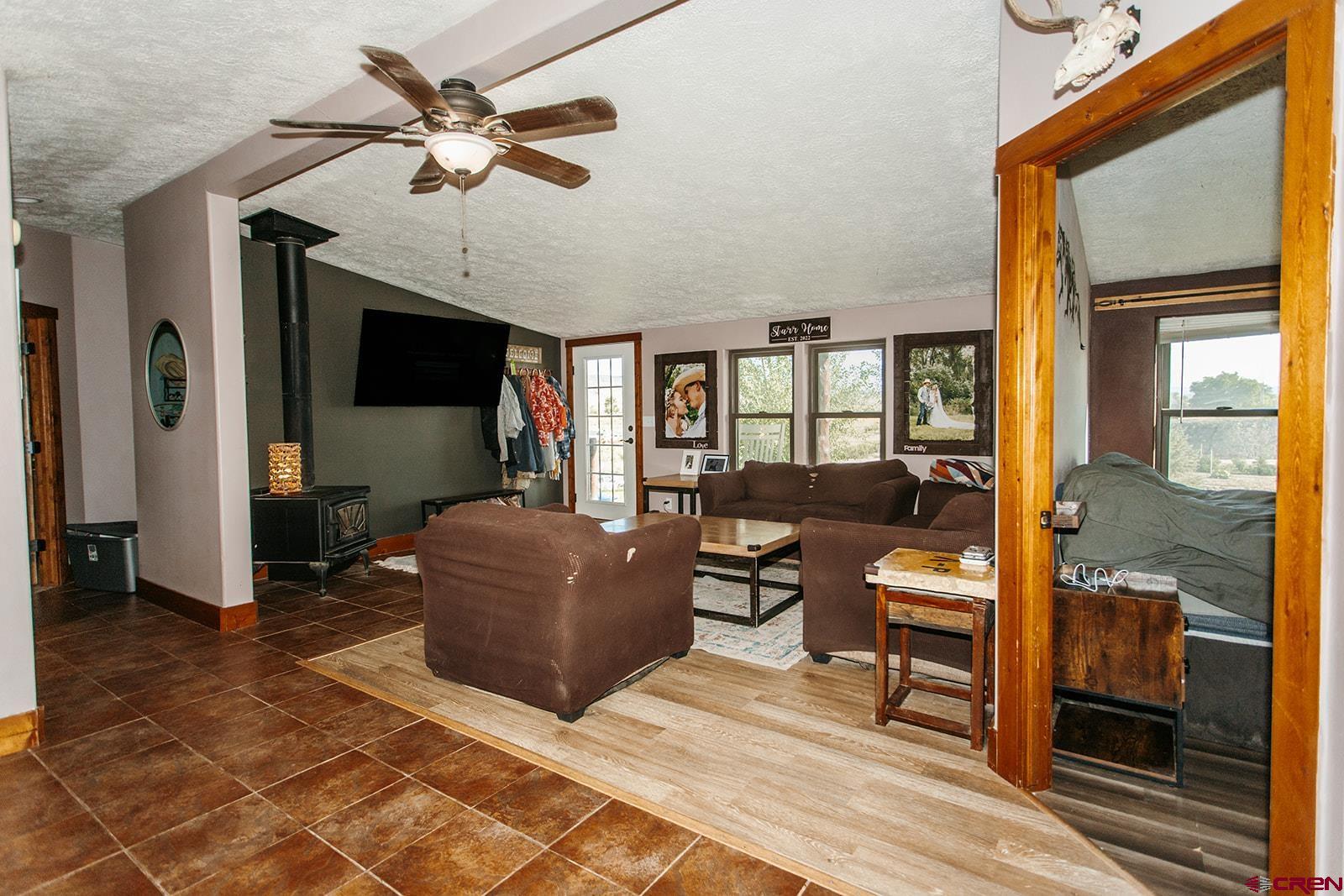 5697 Peach Valley Road Delta, CO 81416 - Photo 3 of 31 a living room with furniture and a flat screen tv