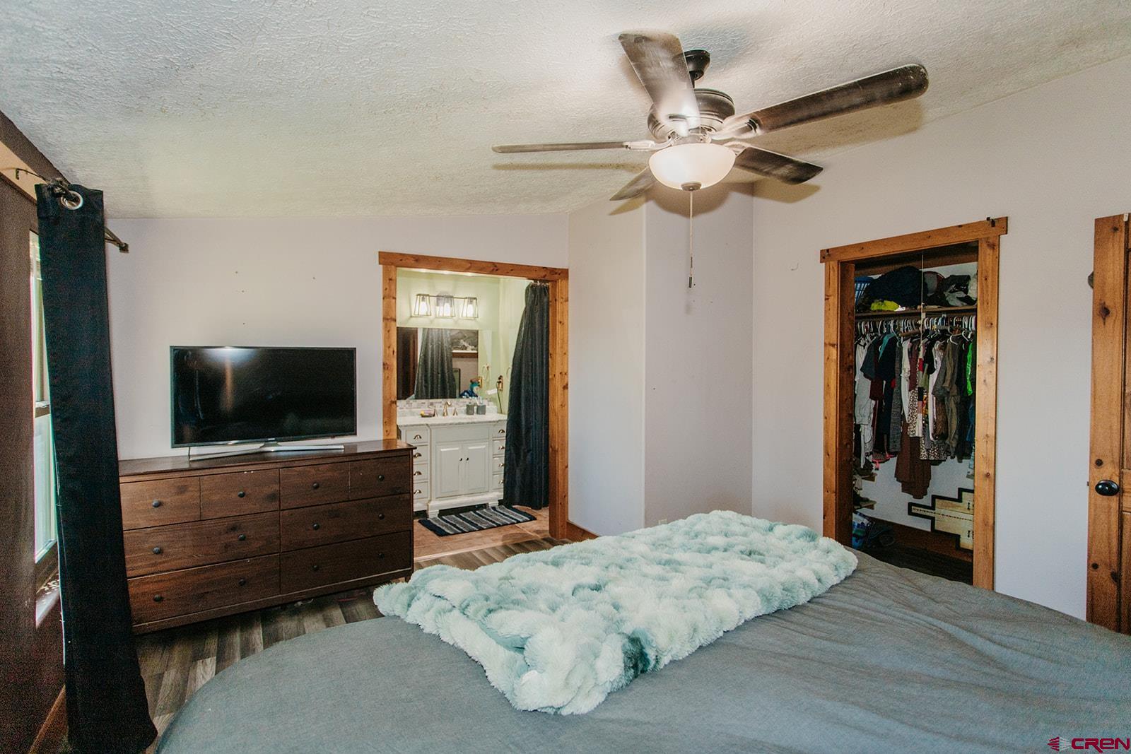 5697 Peach Valley Road Delta, CO 81416 - Photo 5 of 31 a bedroom with a bed and a flat screen tv