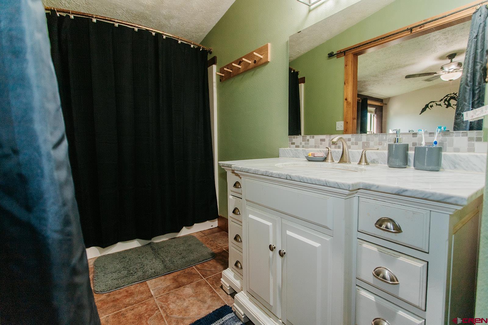 5697 Peach Valley Road Delta, CO 81416 - Photo 6 of 31 a bathroom with a sink and a mirror