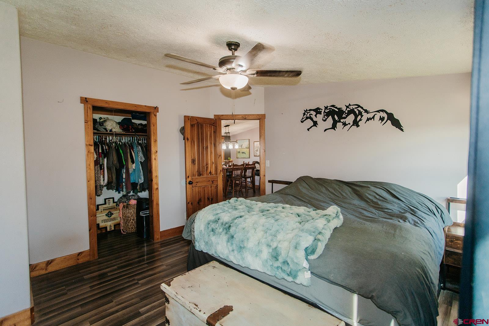 5697 Peach Valley Road Delta, CO 81416 - Photo 7 of 31 a bedroom with a bed and a chandelier