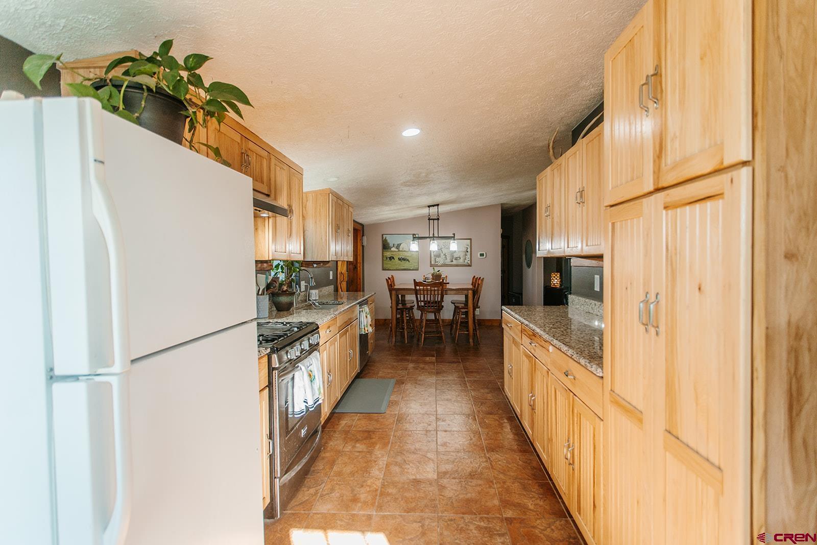 5697 Peach Valley Road Delta, CO 81416 - Photo 10 of 31 a view of a kitchen from the hallway