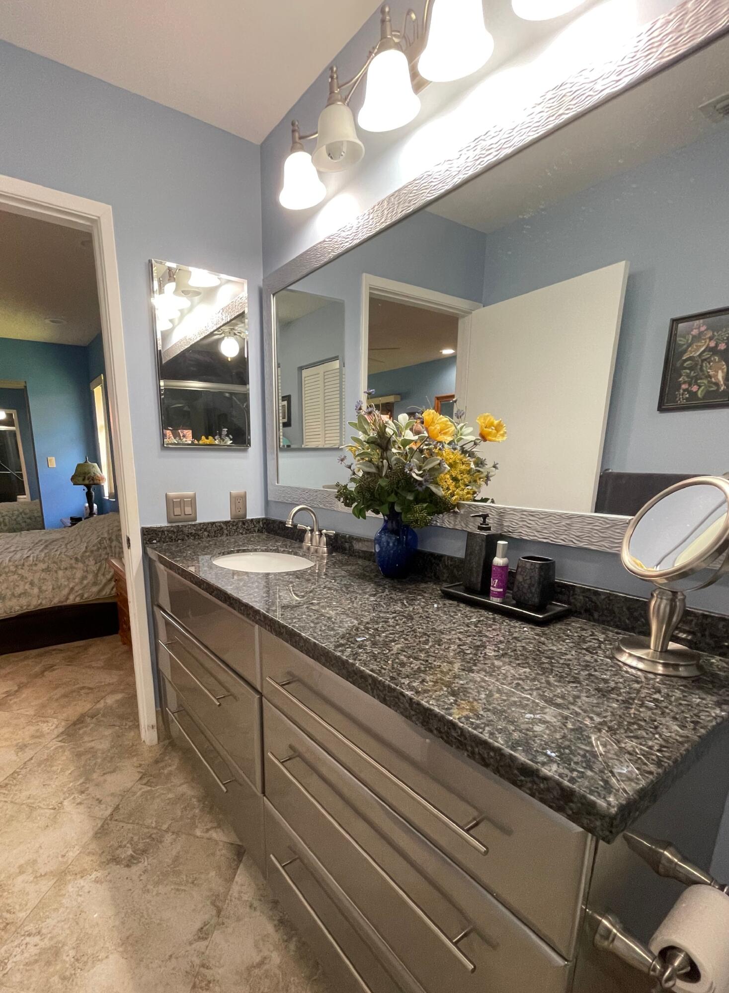6141 Sunny Pointe Circle, Unit B Delray Beach, FL 33484 - Photo 19 of 62 a bathroom with a granite countertop sink and a mirror