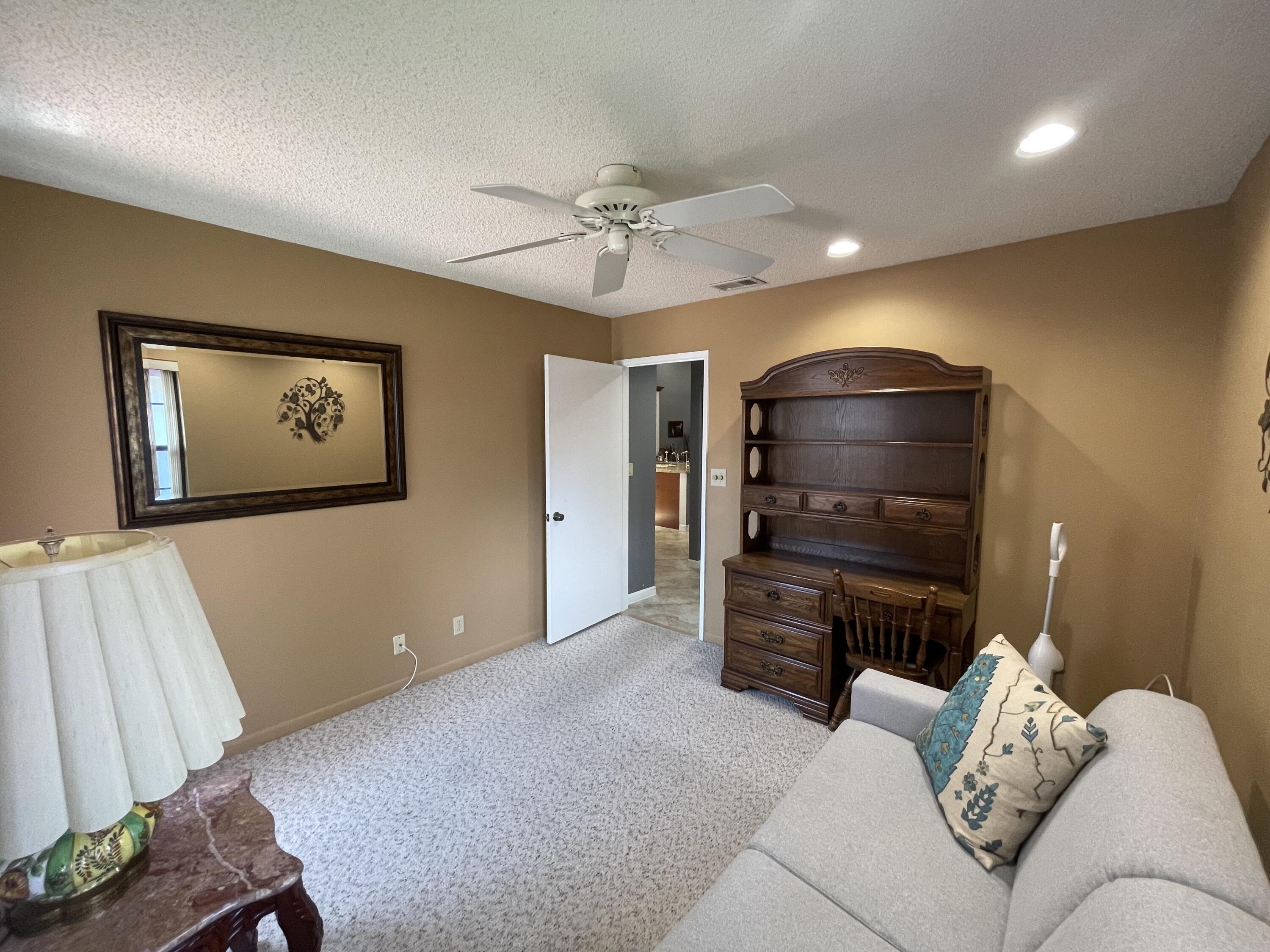 6141 Sunny Pointe Circle, Unit B Delray Beach, FL 33484 - Photo 26 of 62 a living room with furniture and a flat screen tv