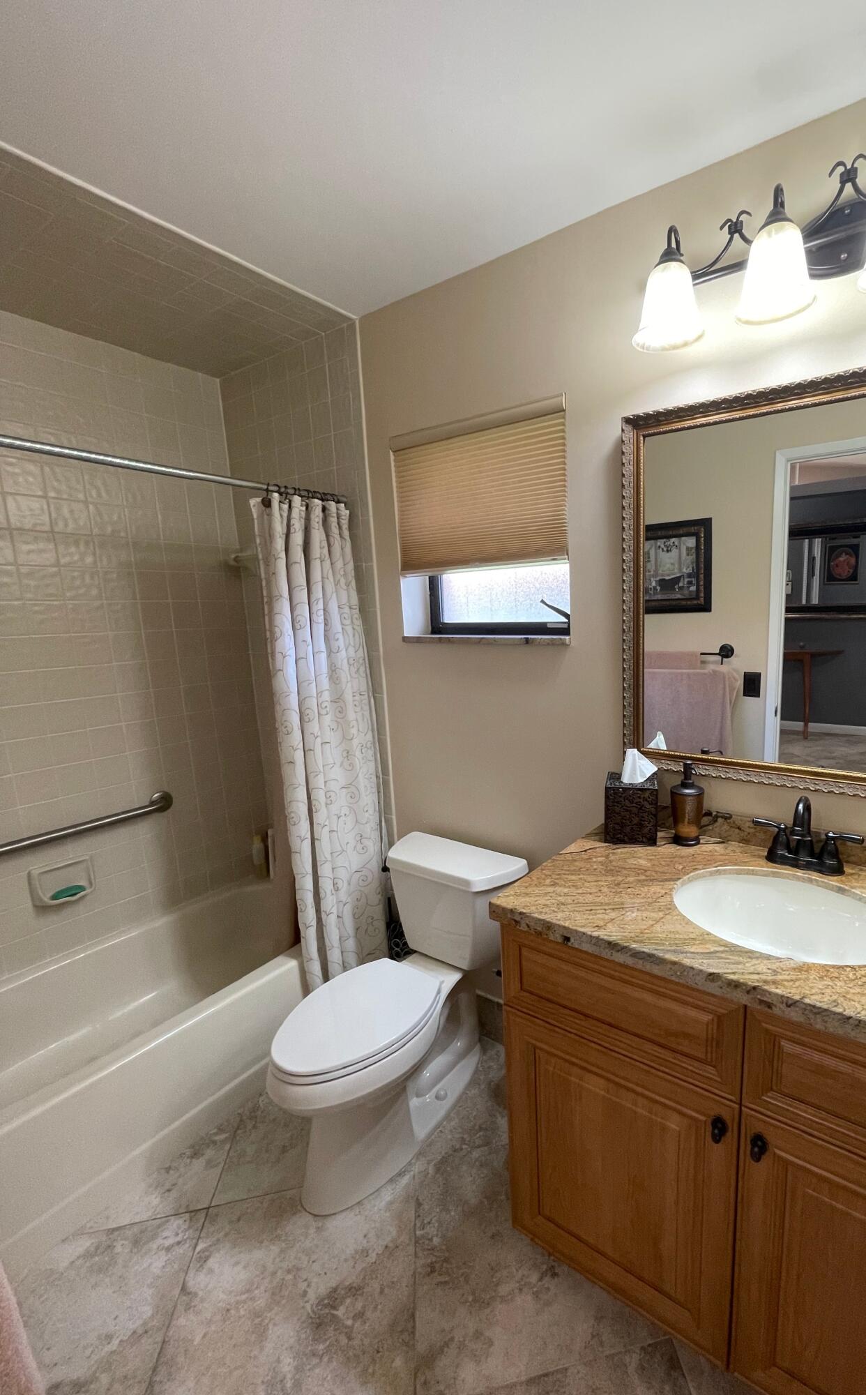6141 Sunny Pointe Circle, Unit B Delray Beach, FL 33484 - Photo 28 of 62 a bathroom with a sink a toilet and shower