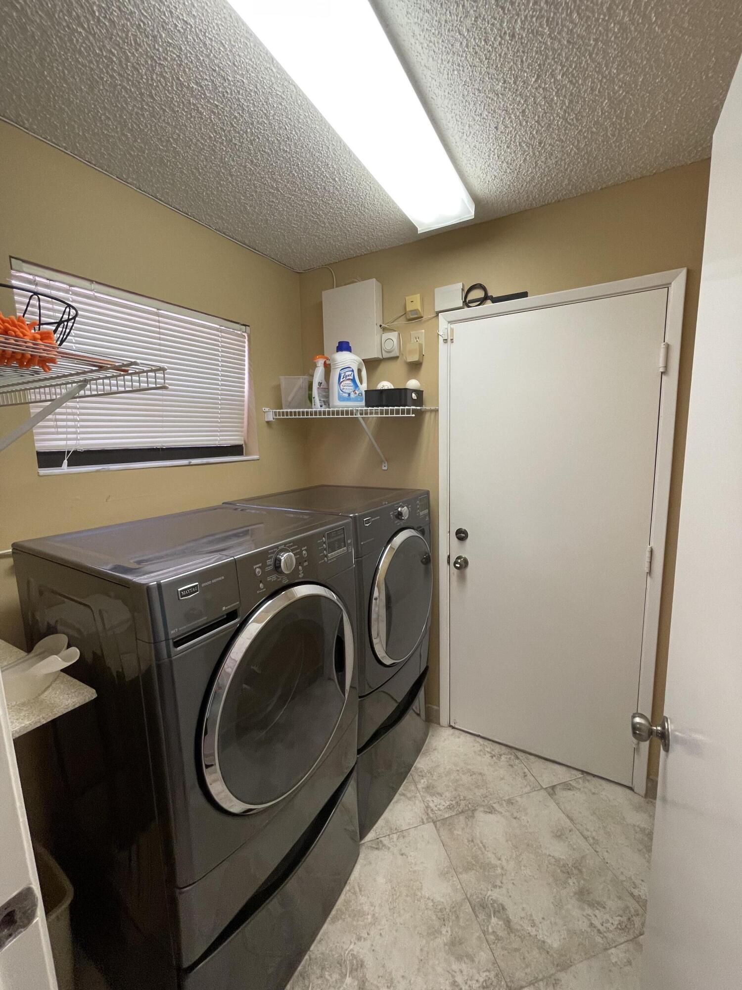 6141 Sunny Pointe Circle, Unit B Delray Beach, FL 33484 - Photo 29 of 62 a utility room with dryer and washer