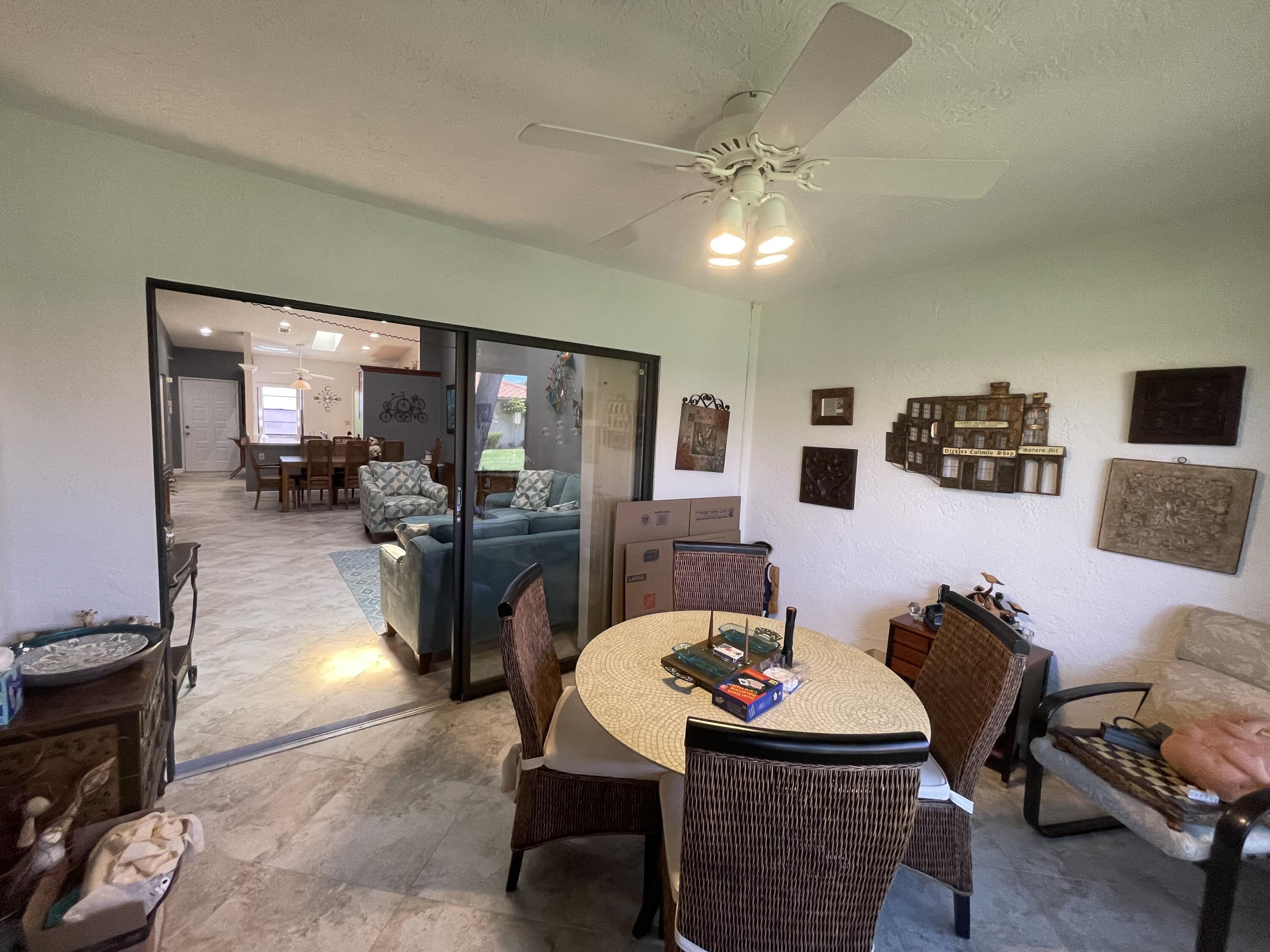 6141 Sunny Pointe Circle, Unit B Delray Beach, FL 33484 - Photo 31 of 62 a living room with furniture and kitchen view
