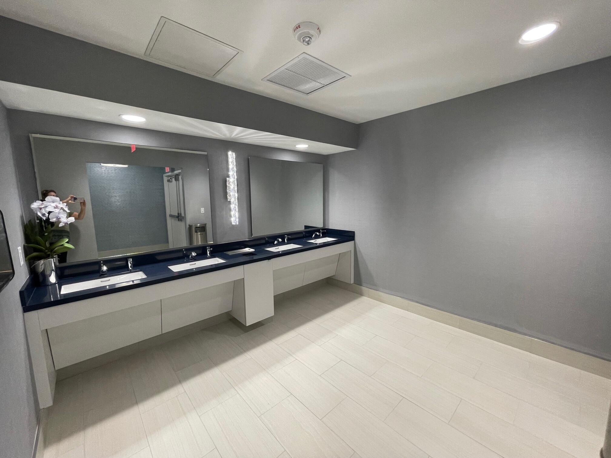 6141 Sunny Pointe Circle, Unit B Delray Beach, FL 33484 - Photo 48 of 62 a large white kitchen with a sink and dishwasher a stove top oven with wooden floor