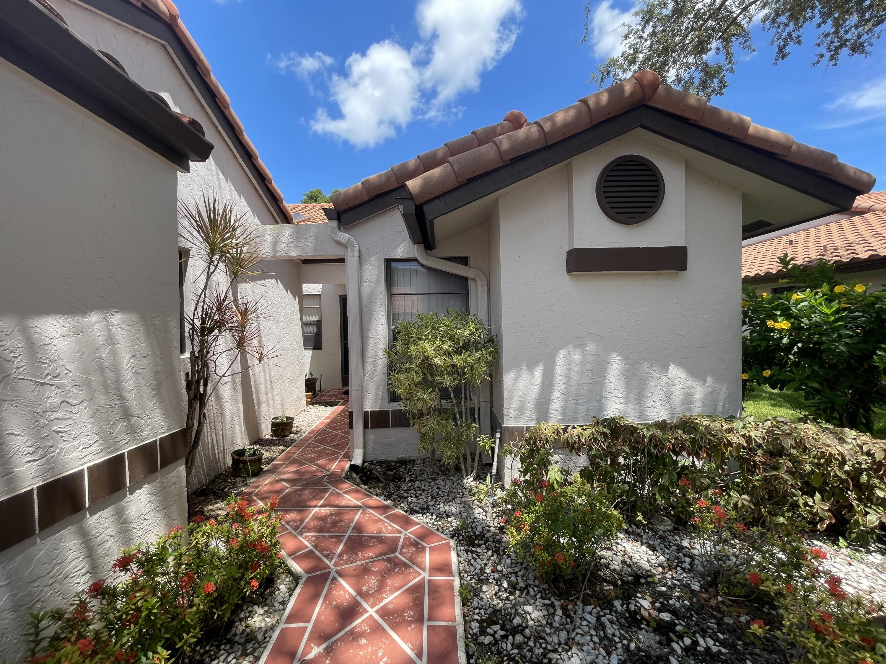 6141 Sunny Pointe Circle, Unit B Delray Beach, FL 33484 - Photo 57 of 62 a house view with a outdoor space