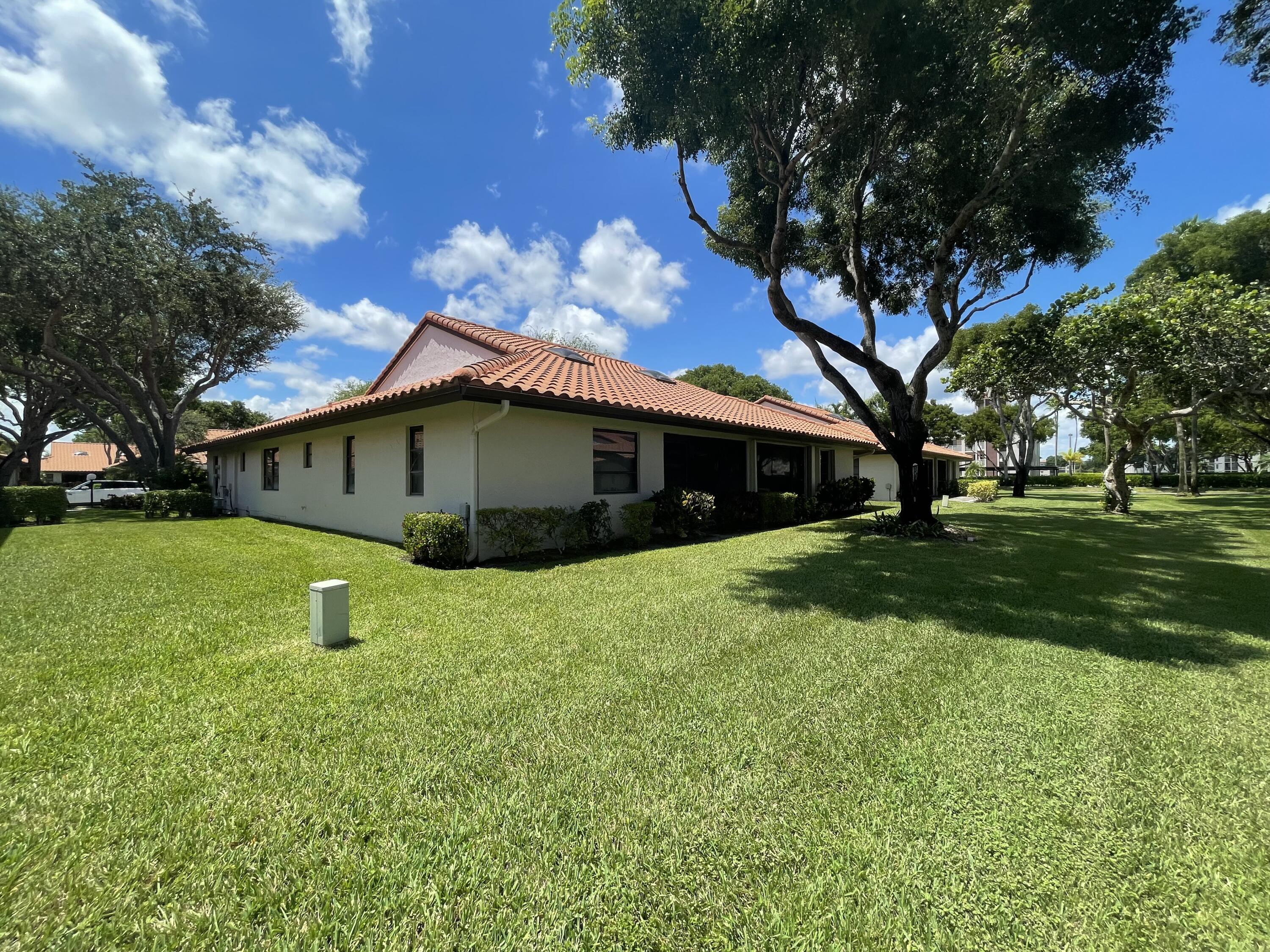 6141 Sunny Pointe Circle, Unit B Delray Beach, FL 33484 - Photo 58 of 62 a house view with a garden space