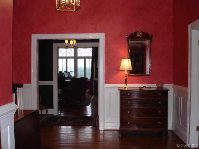 3812 Old Gun Road West Midlothian, VA 23113 - Photo 5 of 10 a view of a hallway with wooden floor and a cabinet