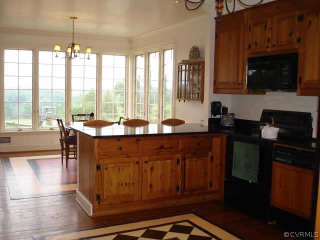 3812 Old Gun Road West Midlothian, VA 23113 - Photo 9 of 10 a kitchen with a sink wooden cabinets and a granite counter top
