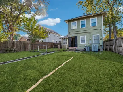a view of a house with a big yard and large trees