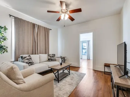 a living room with furniture and a flat screen tv