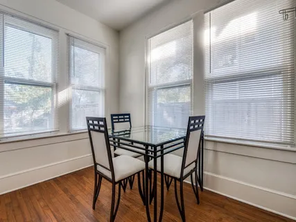 a view of a dining room with furniture and windows