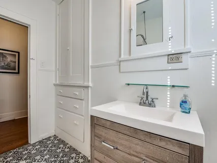 a bathroom with a sink and a mirror