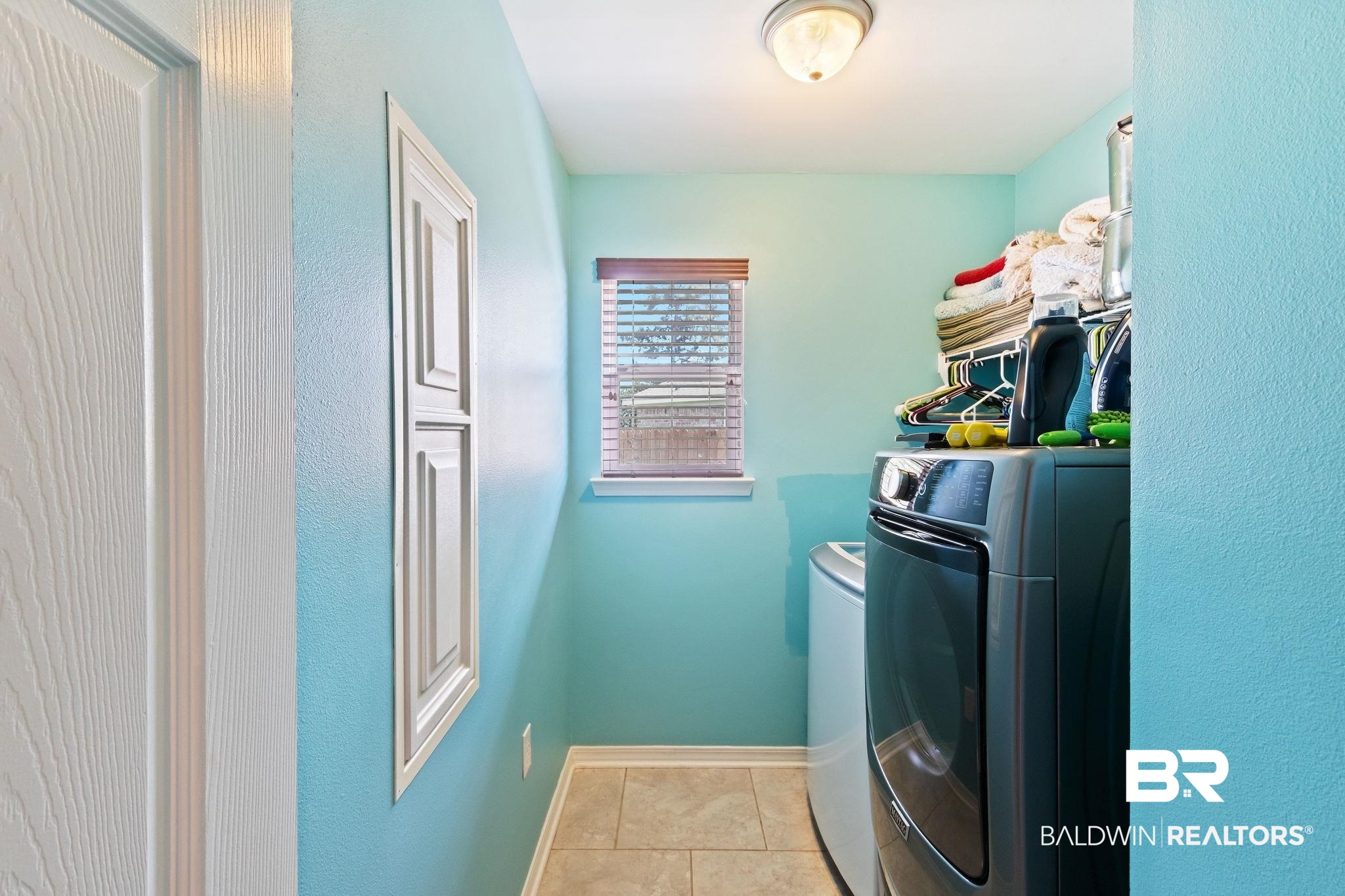 16898 Sugar Loop Foley, AL 36535 - Photo 40 of 67 Laundry area featuring washer and dryer and light tile patterned floors
