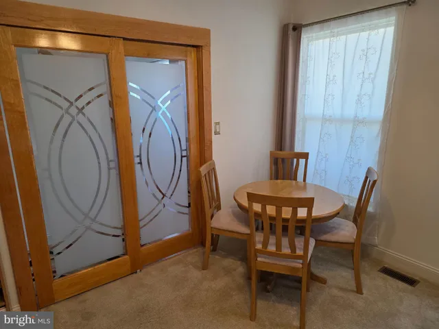 a dining room with furniture and a mirror