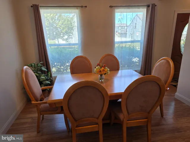 a dining room with furniture and window