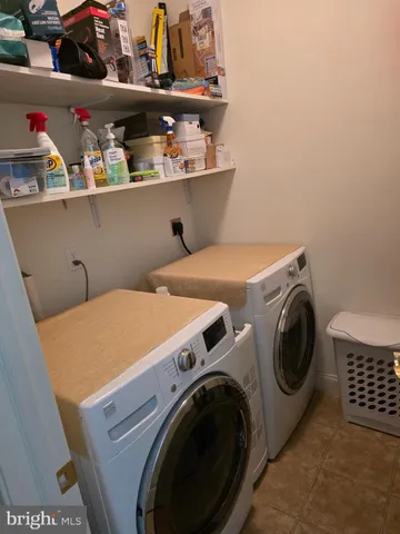 a living room with furniture a fireplace and a window