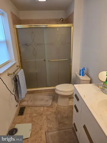 a view of an empty room with cabinet and stairs