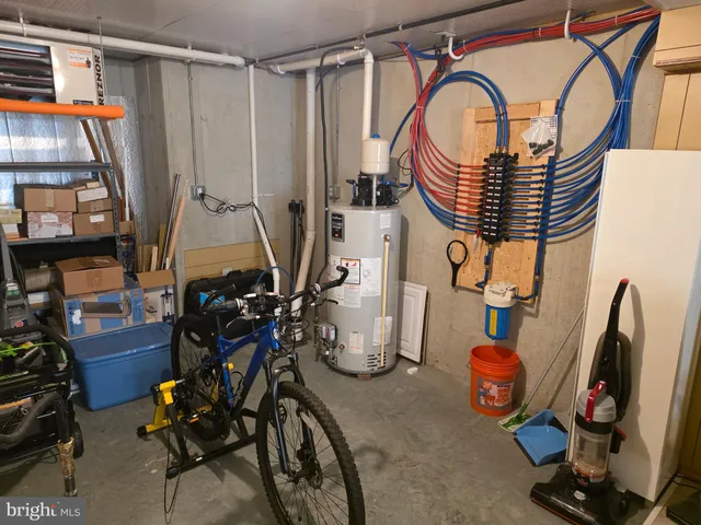 a close view of walk in closet with clothes and shoes