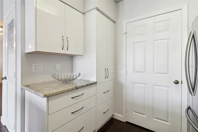 a kitchen with white cabinets and a sink