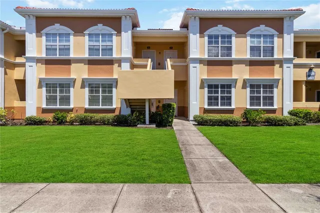 front view of a brick house with a yard