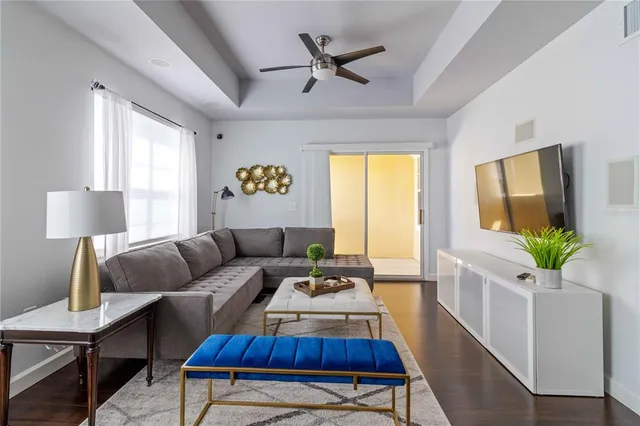 a living room with furniture and a wooden floor