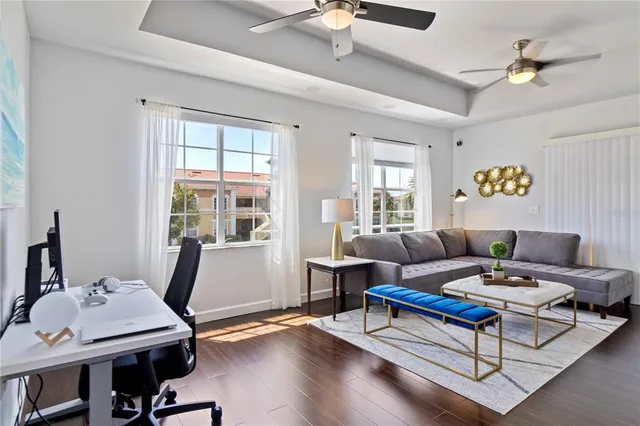 a living room with furniture and wooden floor