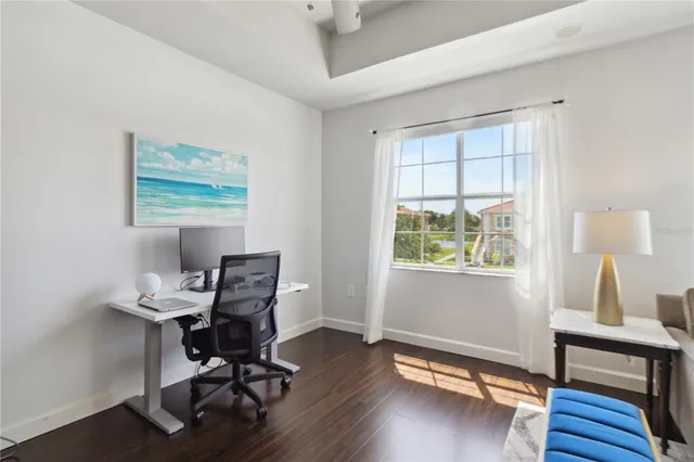 a view of a workspace with furniture and a window