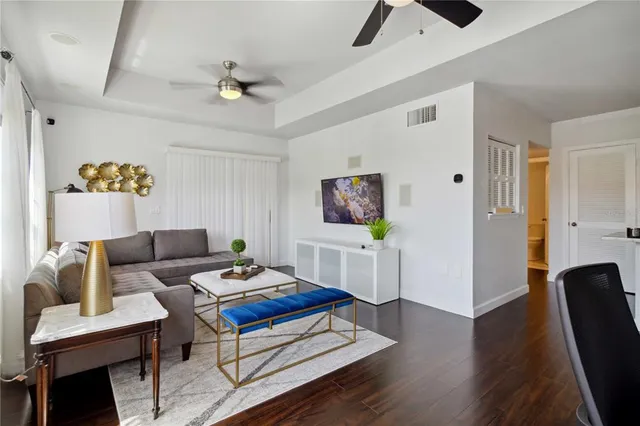 a living room with furniture and a wooden floor