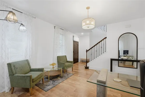 a view of a workspace with furniture and a window