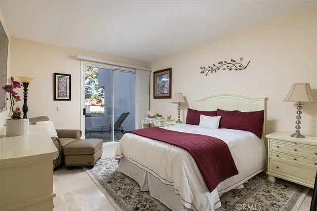 a bedroom with a large bed and a couch