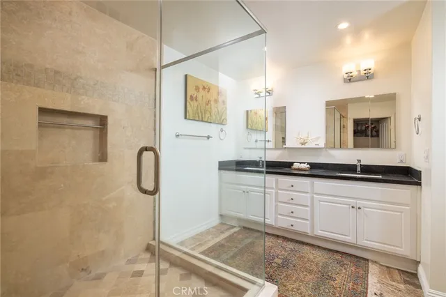 a spacious bathroom with double sink and a mirror