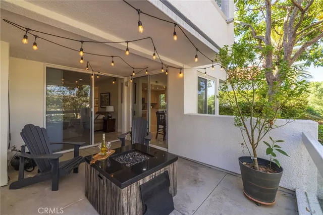 a living room with a rug and a glass door shower