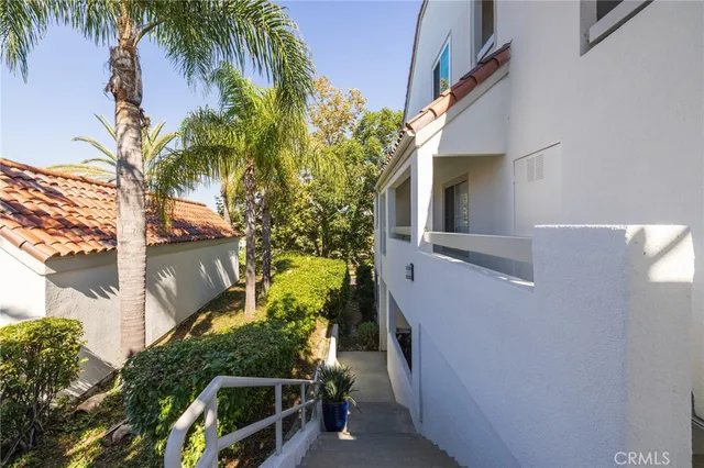 a view of a pathway of a house with a yard