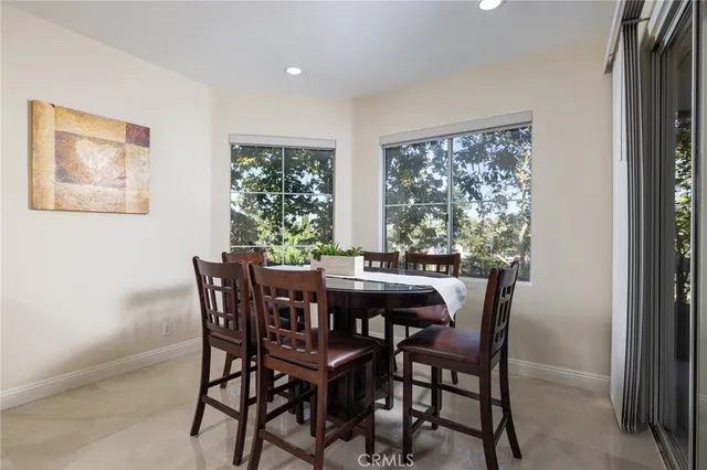 a view of a dining room with furniture and window